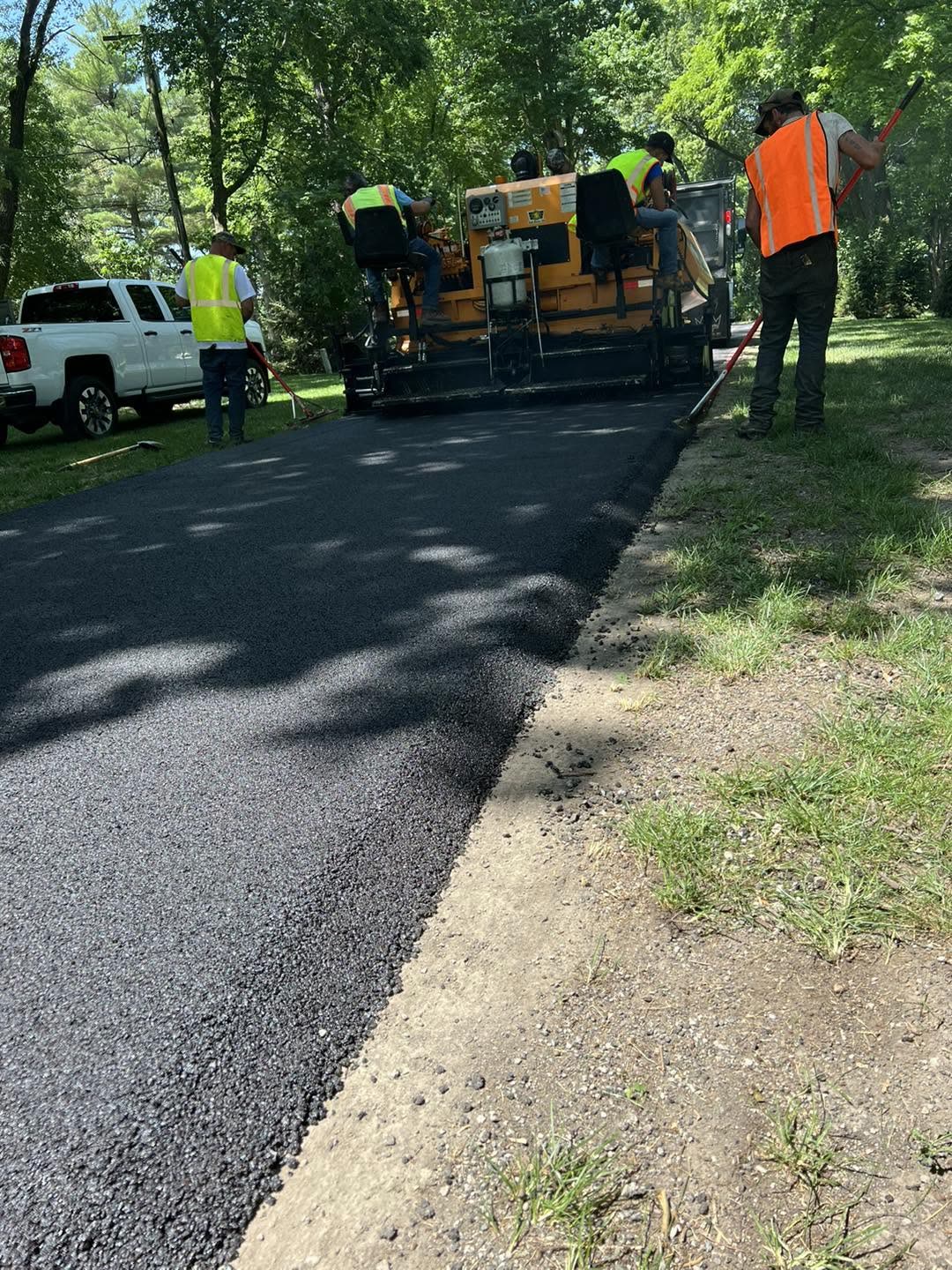 Cornell's crew paving a residential driveway with the paver and roller
