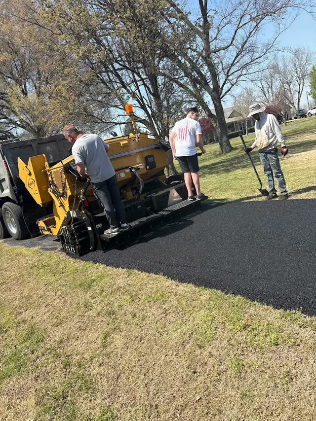 Hot asphalt in the paver hopper mid-laydown