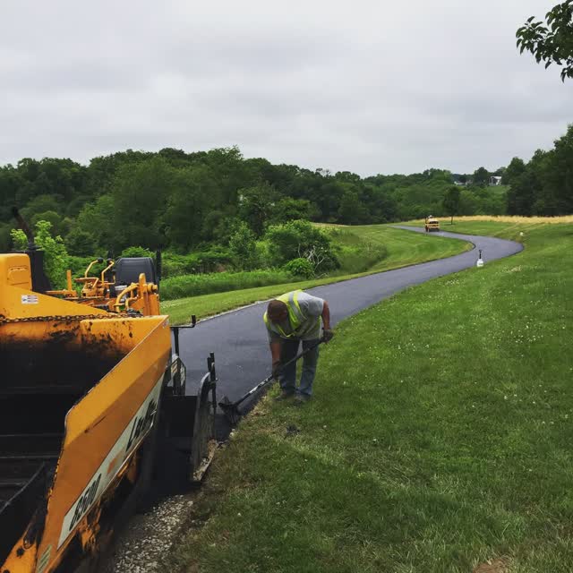 LeeBoy paver screeding hot mix on a winding path